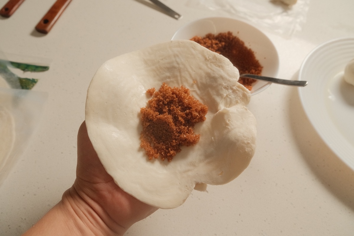 Cinnamon sugar placed in the centre of flattened paratha dough