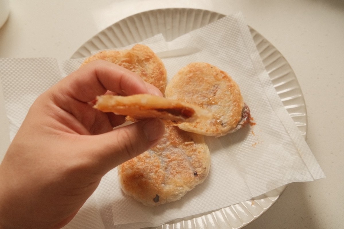 Split paratha hotteok showing its cinnamon sugar centre