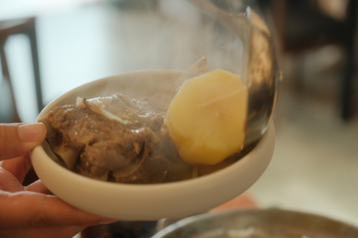 Tender pork and potato served from GAMJA's white gamjatang