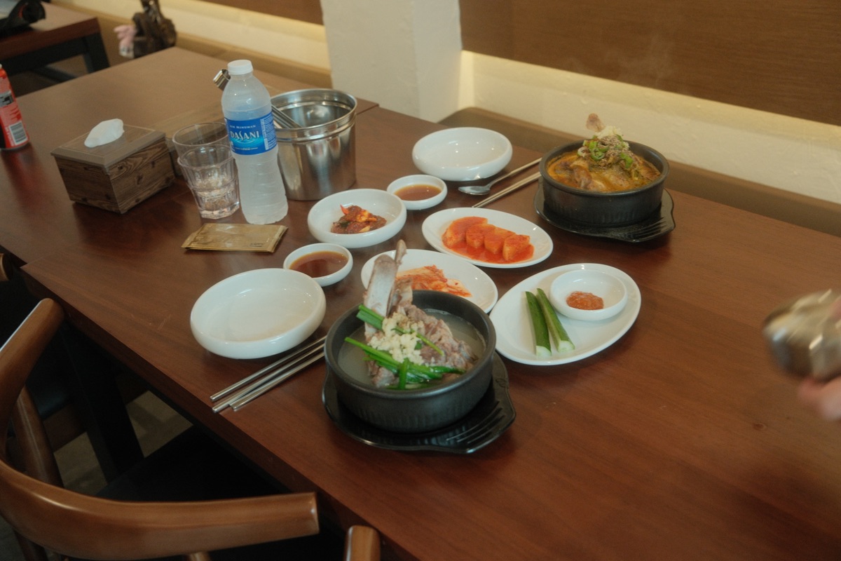GAMJA lunch table with individual gamjatang bowls and banchan