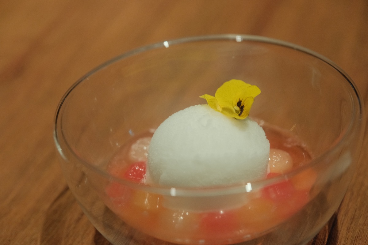 GU:UM hwachae served with fruit and a white sorbet under an edible flower