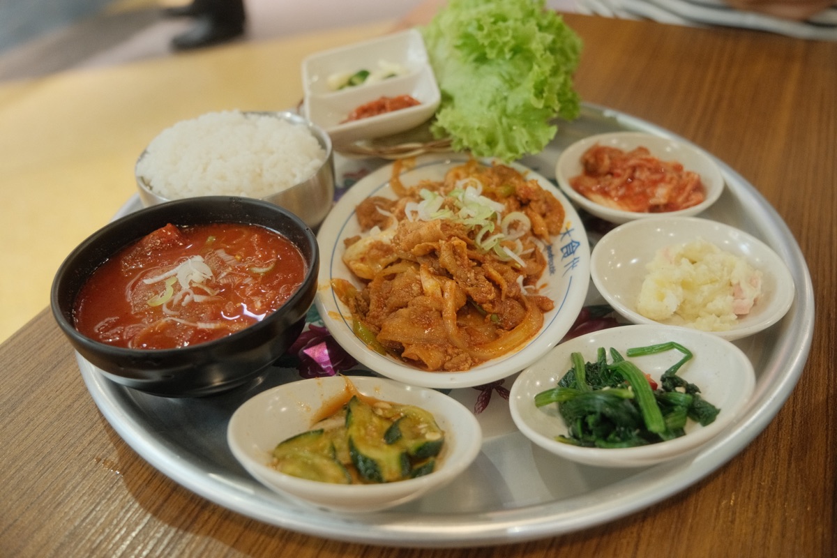 Sweet and spicy pork baekban with rice, soup, banchan and lettuce