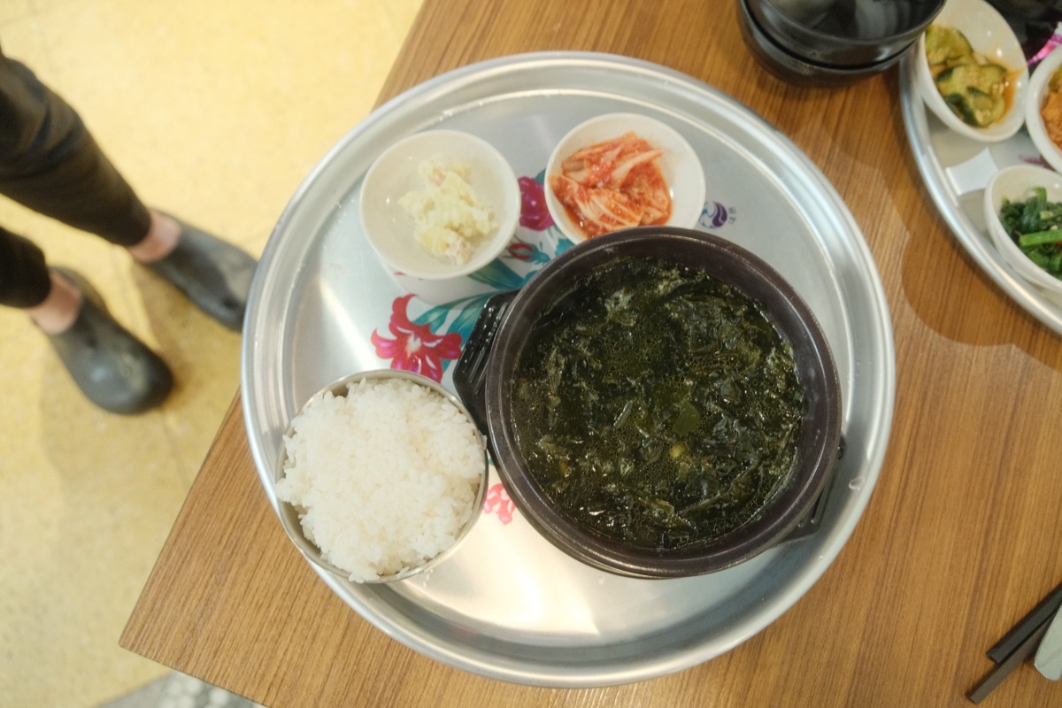 Chicken seaweed soup served with rice, kimchi and potato salad