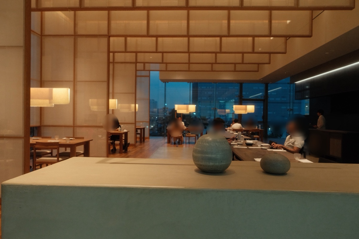 Na Oh dining room with hanji paper partitions and warm wood