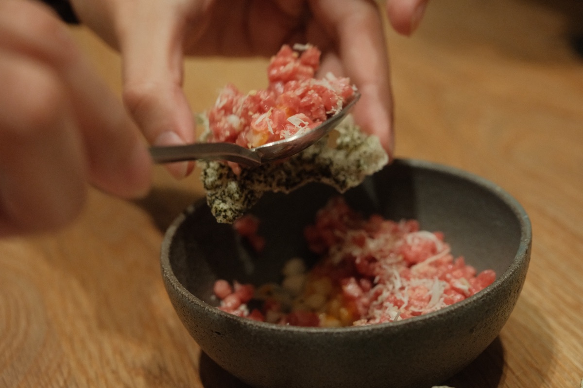 Scooping tartare onto bugak