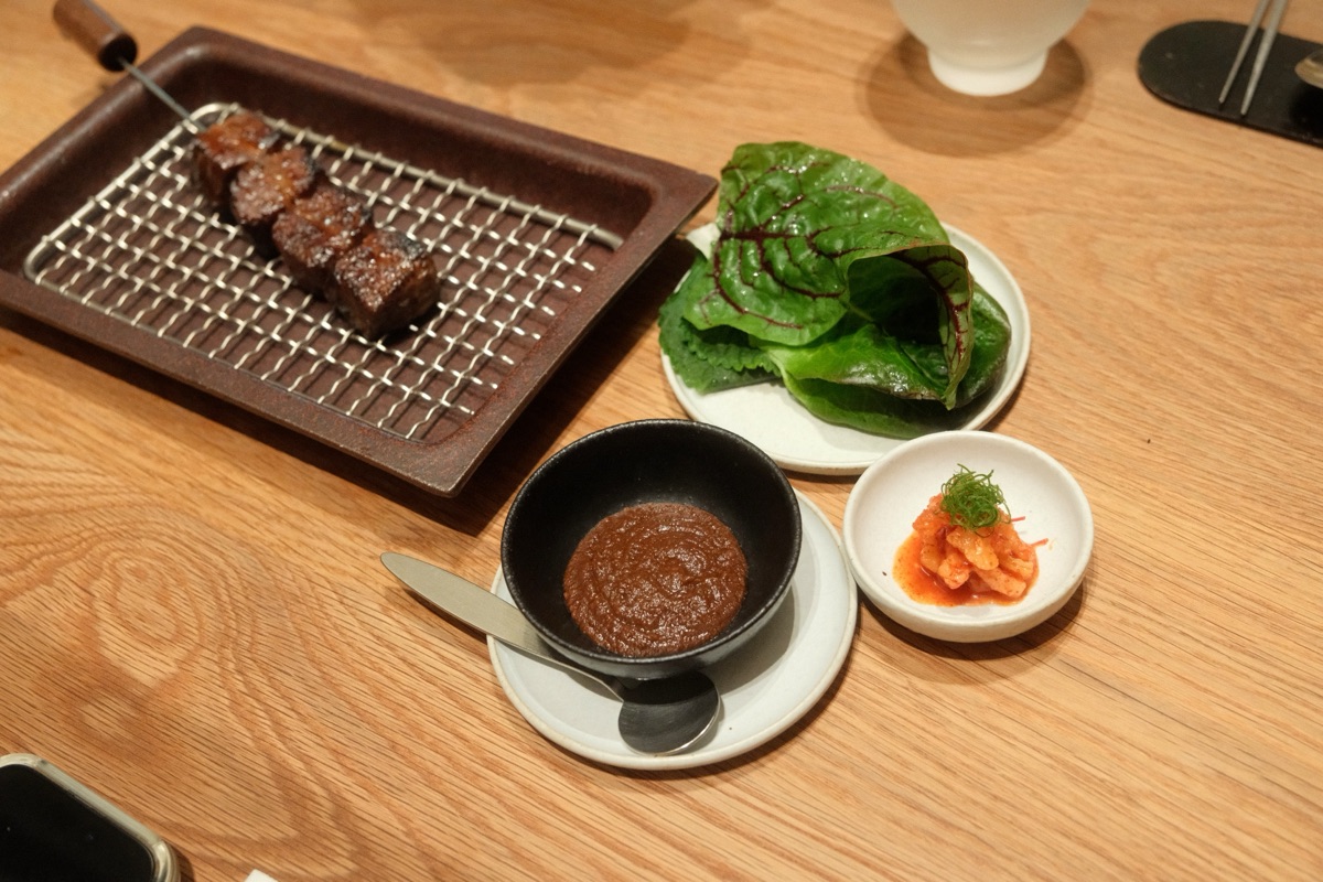 The full Hanwoo rib finger spread with ssamjang, greens, and kimchi