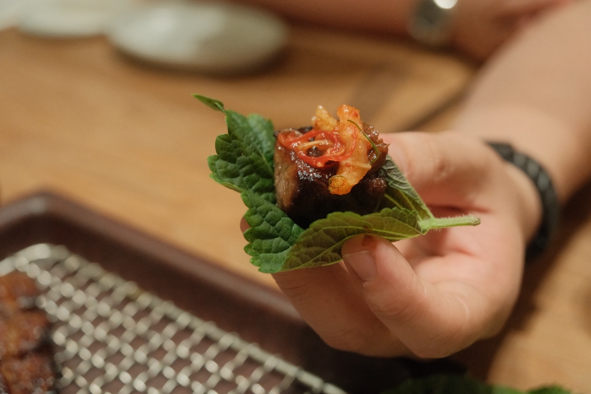 Hanwoo rib finger ssam wrap with greens and kimchi