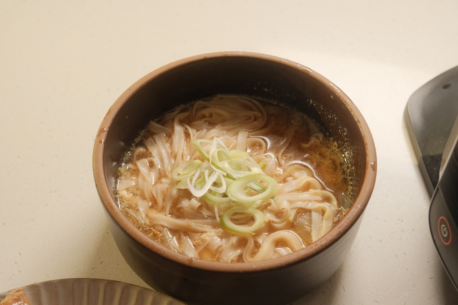 North Korean steamed chicken served with dipping sauce and kalguksu broth