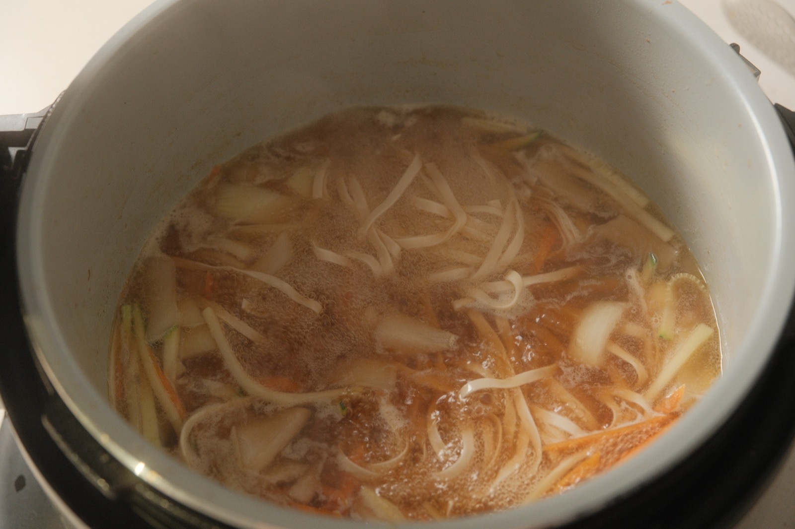Knife-cut noodles served in clear broth with sliced green onion