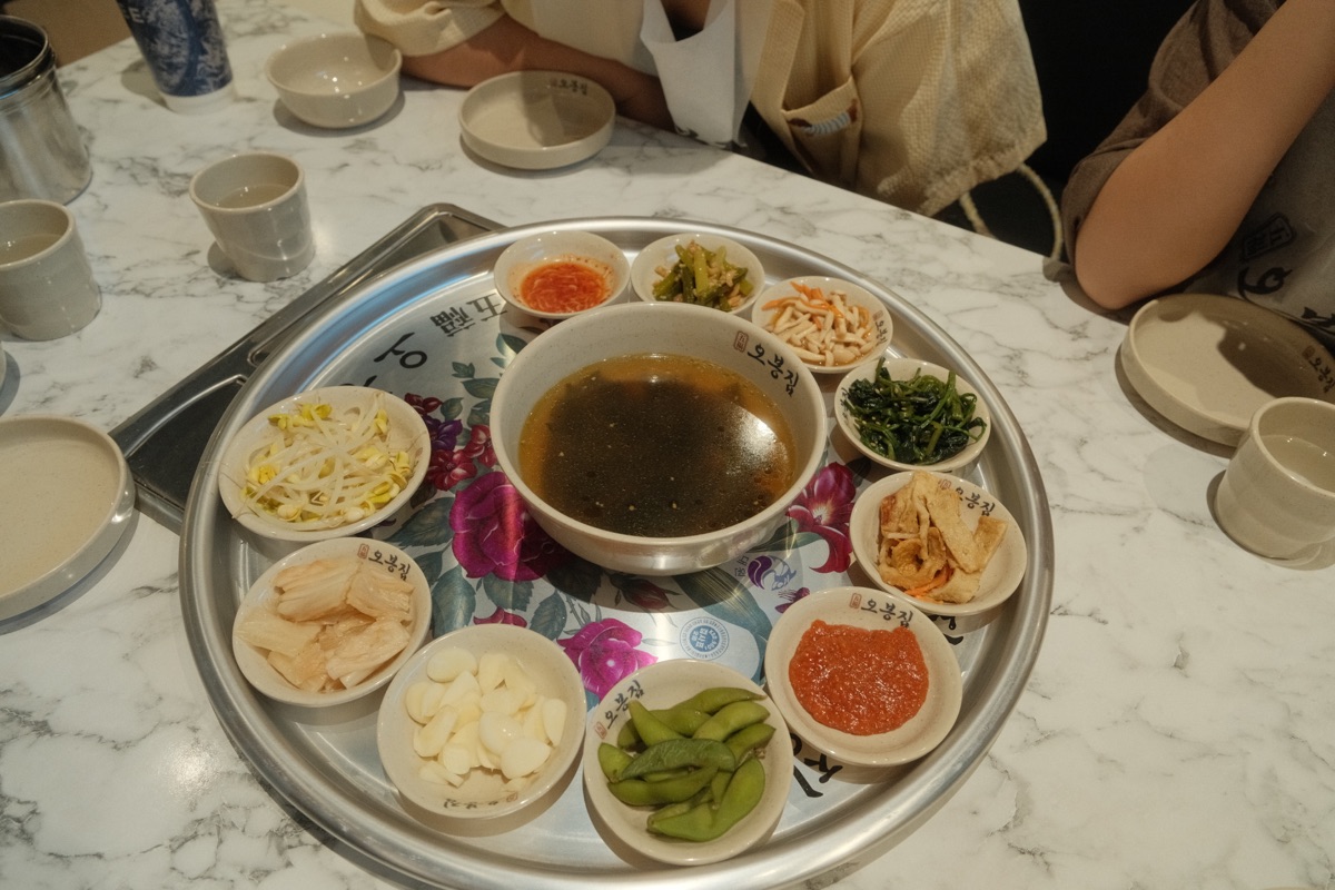 Obongzip banchan and soup arranged on a large serving tray