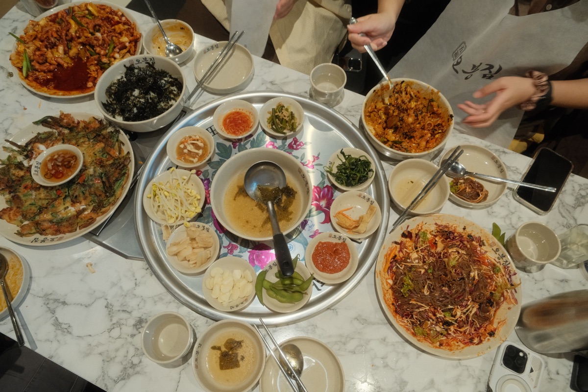 Overhead view of the Obongzip table with octopus, pancakes, banchan and fried rice