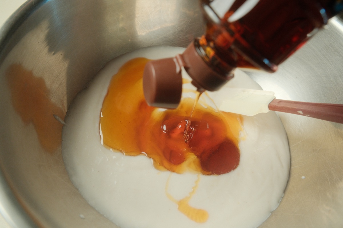 Rice syrup being poured into the cooled glutinous rice mixture